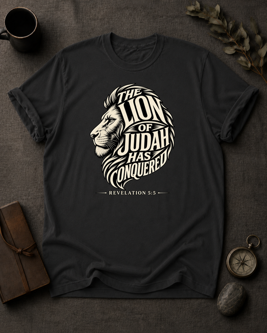 black Comfort Colors t-shirt with lion illustration, Revelation 5:5 — 'The Lion of Judah Has Conquered'