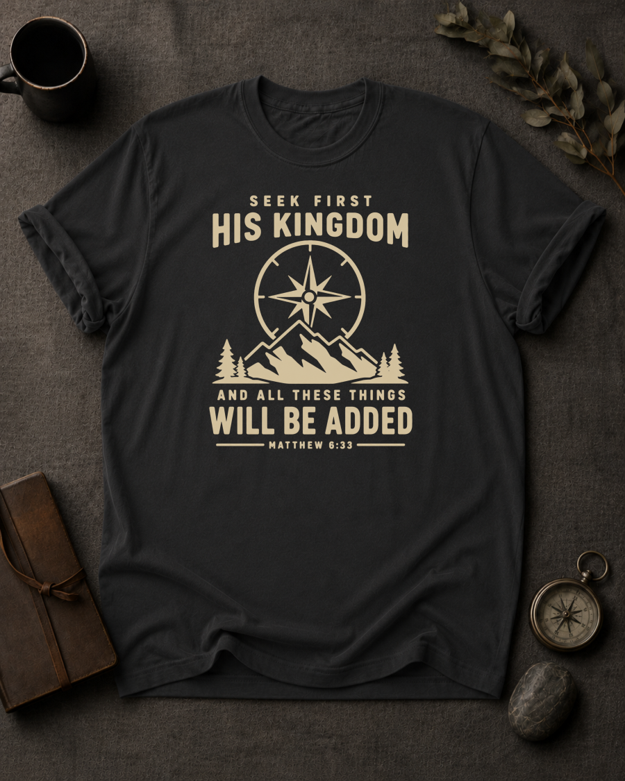 black Comfort Colors t-shirt with compass and mountain design reading 'Seek First His Kingdom, and all these things will be added, Matthew 6:33'"