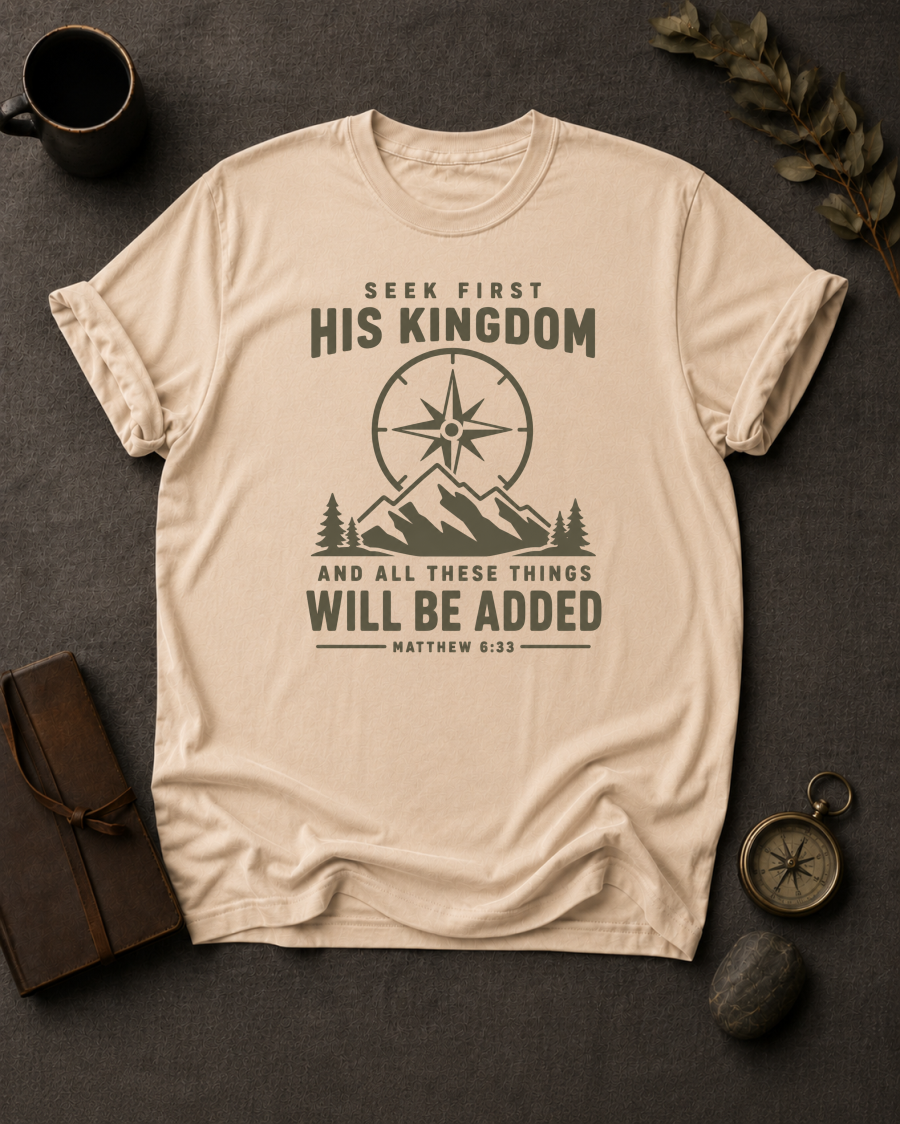 ivory Comfort Colors t-shirt with compass and mountain design reading 'Seek First His Kingdom, and all these things will be added, Matthew 6:33'"